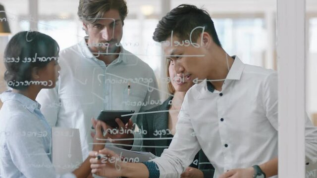 group of business people brainstorming writing ideas on glass whiteboard colleagues working on problem solving solution discussing strategy teamwork in office meeting 4k