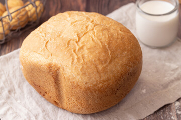a whole loaf of wheat bread on a linen towel