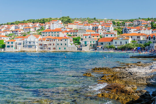 Picturesque bay and the old town of Postira. Postira lies on the northern coast of Brac island in Croatia.