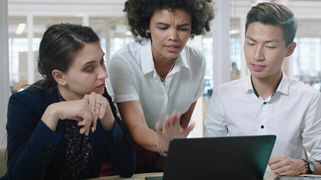 business woman team leader training interns using laptop computer pointing at screen sharing creative ideas helping colleagues discussing project teamwork in modern office 4k