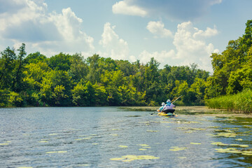 men are rowing on a kayak. Beautiful view of nature and the river