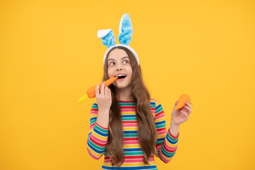 happy easter child girl in rabbit bunny ears eating carrot on holiday, happy easter