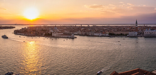 Fototapeta premium Magical evening sunset view over beautiful Venice in Italy. Aerial view of the Venice lagoon with a beautiful city view.