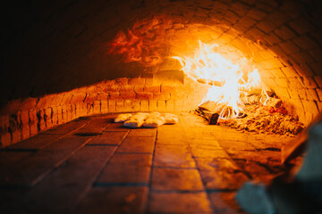 Selective focus of doughs baking in a masonry oven of a restaurant