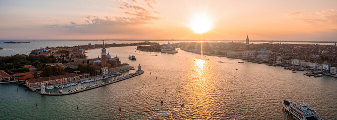 Magical evening sunset view over beautiful Venice in Italy. Aerial view of the Venice lagoon with a...