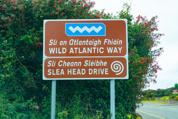 Highway sign for Wild Atlantic Way in two languages, Gaelic and English - obrazy, fototapety, plakaty