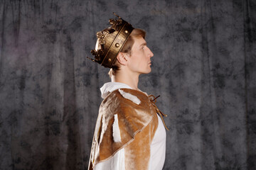 Naklejka premium The young king. A noble young man in a fantasy historical costume,