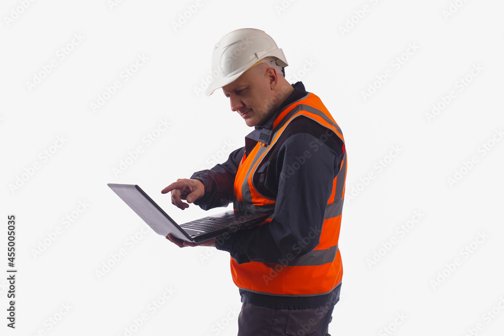 Poster computer foreman in safety helmet. concept builder with laptop. builder is standing and holding lapt