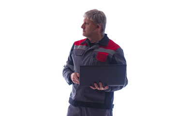Fototapeta premium Gray-haired computer technician on white background. He will set up laptop while standing. computer technician in gray uniform. Experienced computer technician working. System administrator portrait