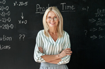Happy smiling middle aged woman mature high school education math teacher or college professor...
