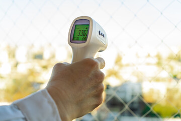 Digital Infrared Thermometer, thermometer gun, for check forehead temperature measurement screening from Coronavirus COVID-19. Sanitary passport