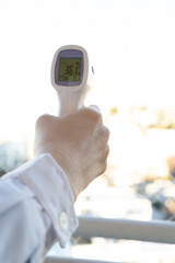 Digital Infrared Thermometer, thermometer gun, for check forehead temperature measurement screening from Coronavirus COVID-19. Sanitary passport