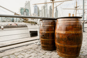 Street table made from wooden old barrels stands on the city's street. Catering. Restaurant. Cafe....