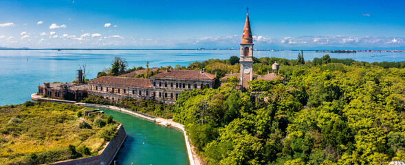 Aerial view of the plagued ghost island of Poveglia in the Venetian lagoon, opposite Malamocco along the Canal Orfano near Venice, Italy. © Aerial Film Studio