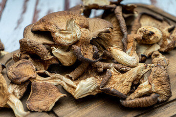 Closeup view from high position of some delicious dried oyster mushrooms on a table on a wooden table.