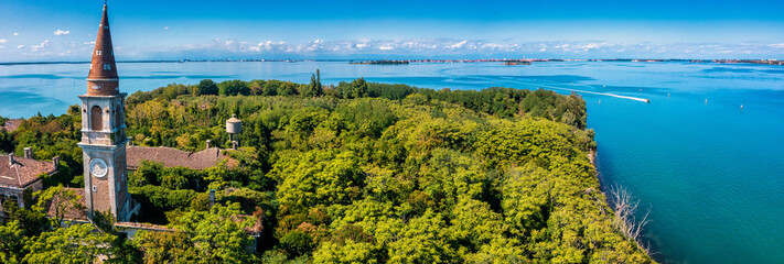 Aerial view of the plagued ghost island of Poveglia in the Venetian lagoon, opposite Malamocco along the Canal Orfano near Venice, Italy. © Aerial Film Studio