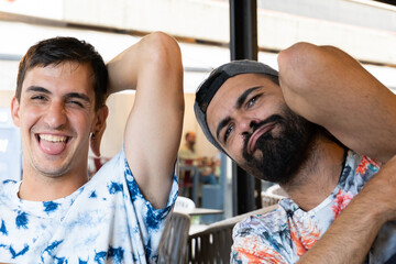 Spanish friends with patterned shirt raising arm