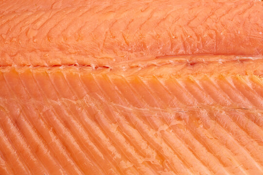 Red fish fillet meat close-up. Trout or salmon, texture and macro photo. Content for an online store or advertising. Seafood close up