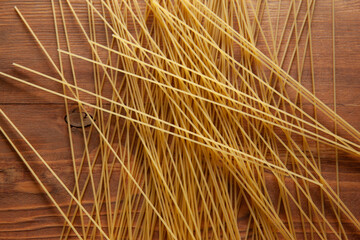 Yellow Spaghetti scattered on the table. Italian food concept. Spaghetti artistic background. High quality photo