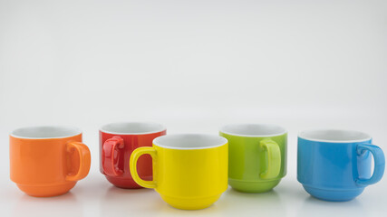 Colorful coffee cup on colorful paper background A lot of cups for coffee and tea in coffee shop Food and drink background concept