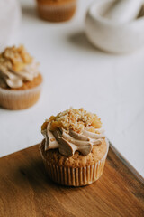Yellow marmalade cupcakes on the rustic wooden table
