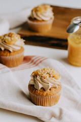 Yellow marmalade cupcakes on the rustic wooden table
