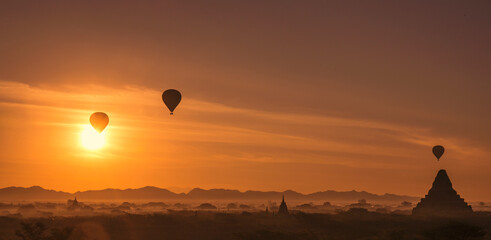 hot air balloon rise up over the ancient temples in Bagan Myanmar at sunrise