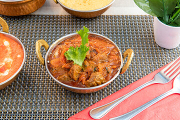 Beef curry cooked with the Indian bhuna technique on a traditional Pakistani metal bowl