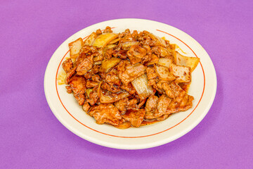 Recipe prepared by a Chinese chef. Stewed beef with onion and soy sauce on purple table