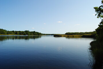 Obraz na płótnie Canvas Calm river landscape with a clear blue sky