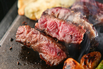 a deliciously cooked beef on a stone plate 돌판위에 먹음직스럽게 익어가고 있는...