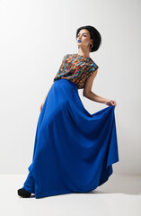 Naklejka premium Fashion photo of young woman in blue dress