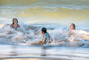 Wild waves and active kids playing  happily in Lake Michigan USA
