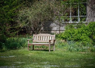 Pretty park bench in a yard, a perfect place to relax and unwinde