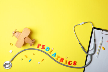  Pediatrics concept. Stethoscope and toy on a light background