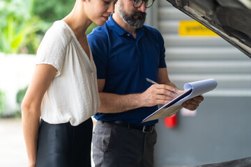 Mechanic man and woman customer check the car condition before delivery. automobile repair...