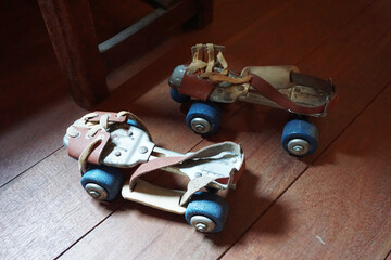 Old roller skate on the wooden floor