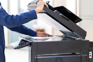Businessman press button on panel of printer photocopier  network , Working on photocopies in the...