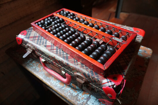 Wooden abacus on old briefcase
