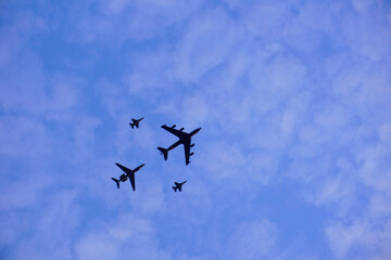 Naklejka na ściany i meble Aircraft flying over the sky during practice
