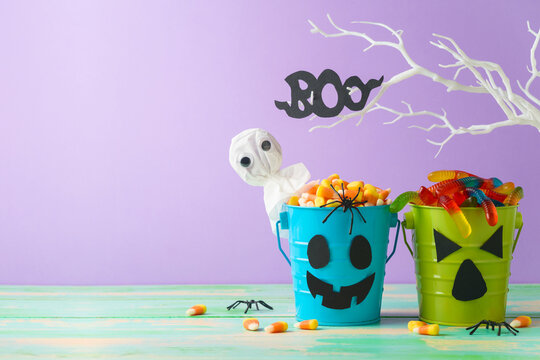 Halloween celebration concept with candy corn and candy in jack o lantern bucket for trick and treat