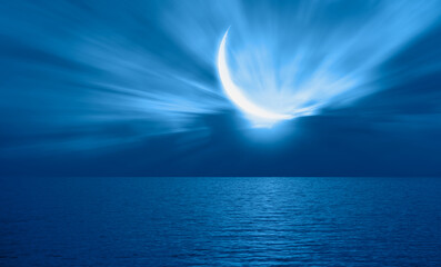 Ramadan Concept - Abstract background with Crescent moon over the sunset clouds