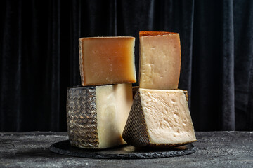 Petit Basque, French cheese, Cheese board of various types of soft and hard cheese. spanish manchego cheese