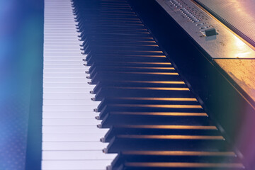 Close-up of a synthesizer or piano keys with highlights.