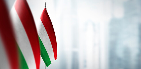 Small flags of Hungary on a blurry background of the city