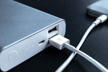 Phone power bank. Mobile phone or smartphone battery charging from portable powerbank with white...