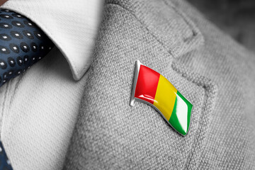 Metal badge with the flag of Guinea on a suit lapel