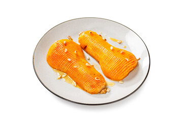 Baked pumpkin or butternut squash with honey served with roasted pine nuts. isolated on white background
