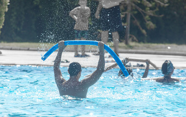 A man does exercises in the pool