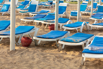 Fototapeta na wymiar Sun loungers on the sandy beach.
